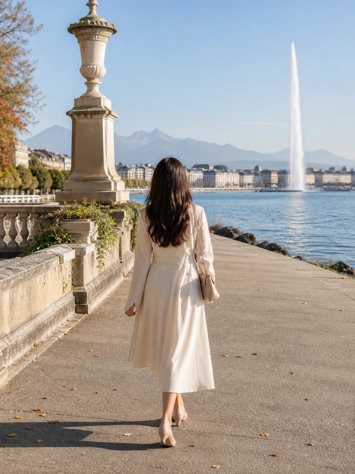 Woman seen from behind beside Lake Geneva in Switzerland